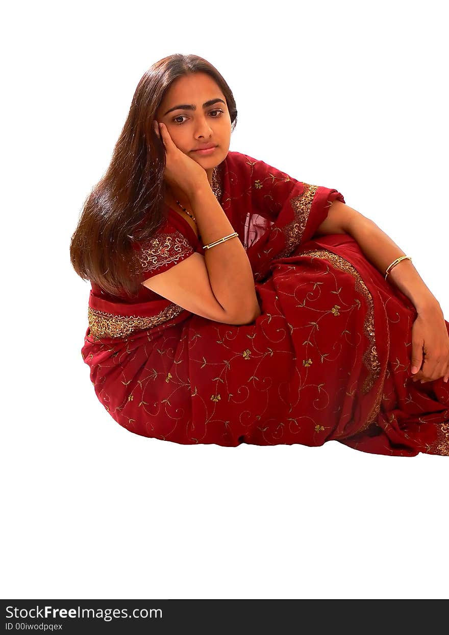 An beautiful Indian lady in her native dress sitting on the floor and the camera from above, on white background. An beautiful Indian lady in her native dress sitting on the floor and the camera from above, on white background.