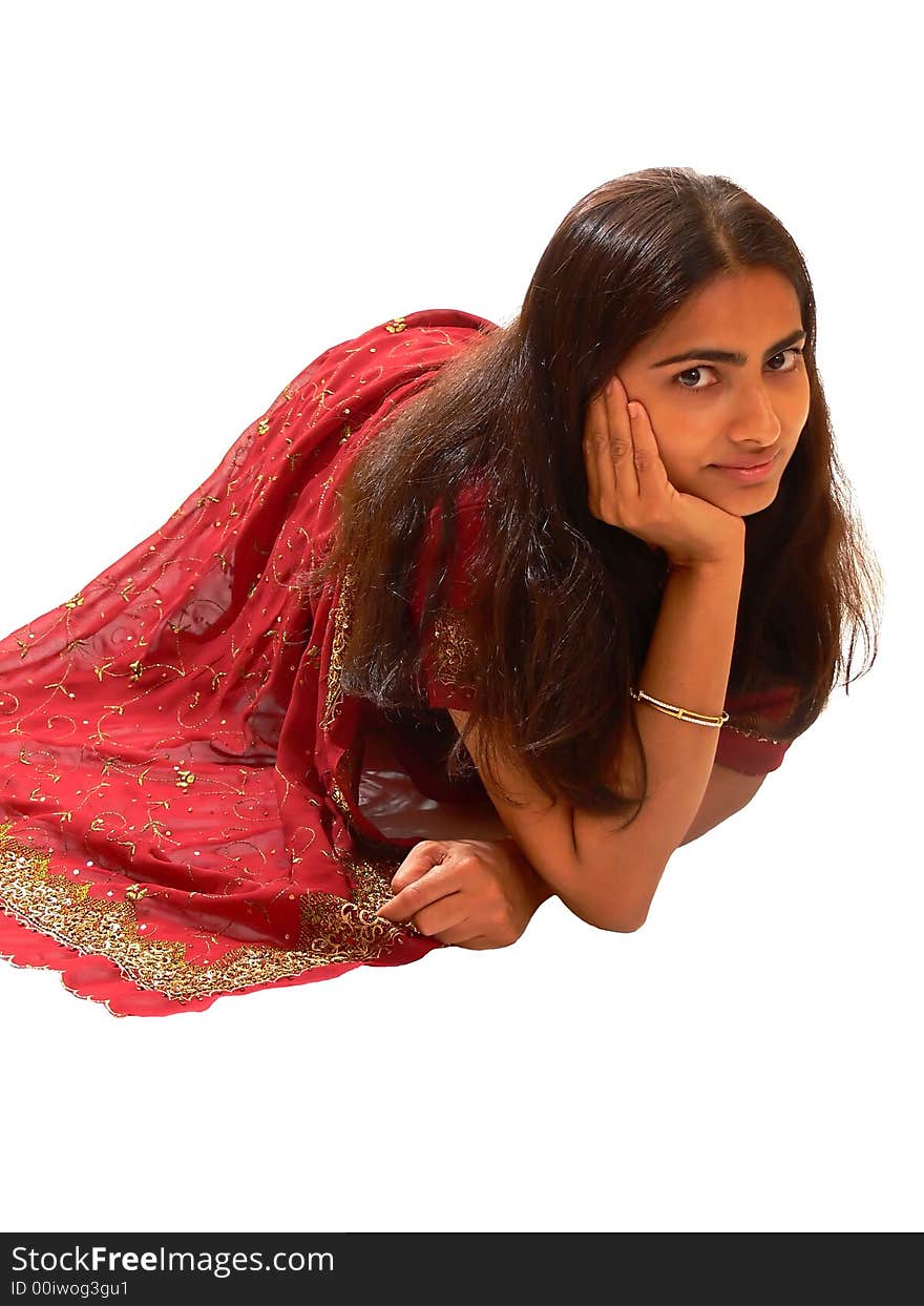 An beautiful Indian lady in her native dress sitting on the floor and the camera from above, on white background. An beautiful Indian lady in her native dress sitting on the floor and the camera from above, on white background.