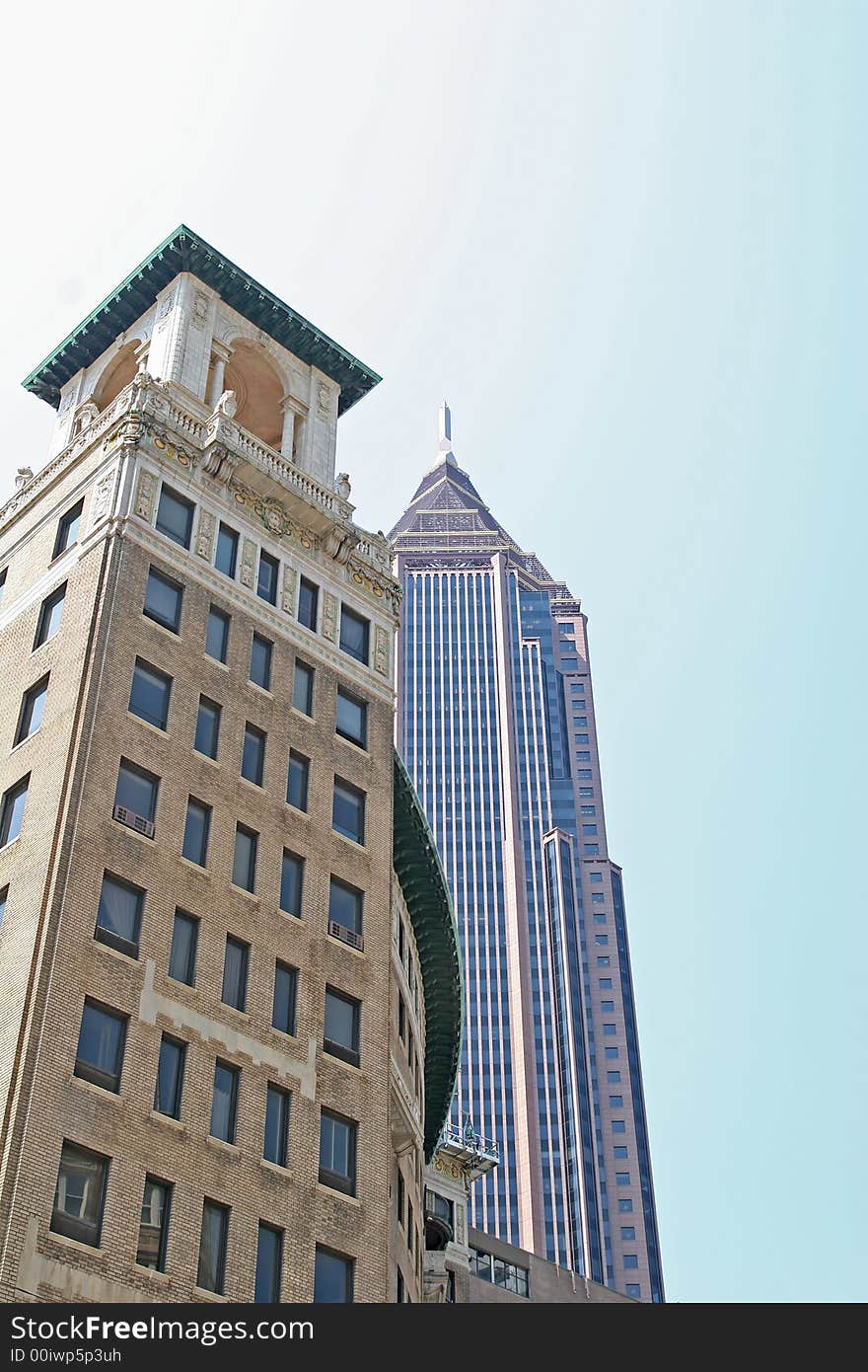 A modern skyscraper with a classic office tower in the foreground. A modern skyscraper with a classic office tower in the foreground