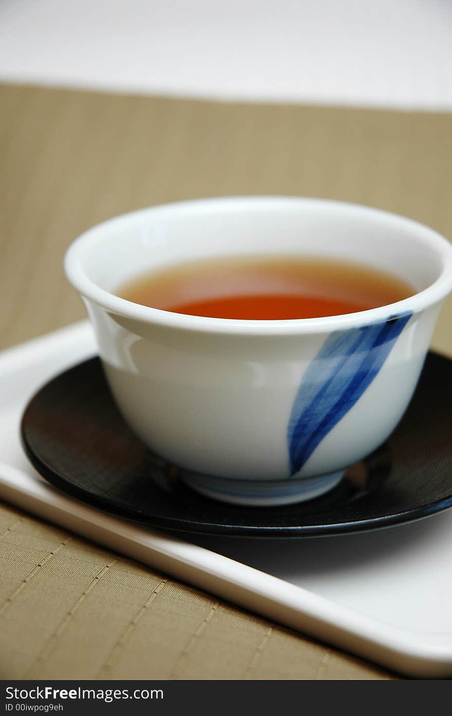 A cup of chinese tea on a brown background. A cup of chinese tea on a brown background