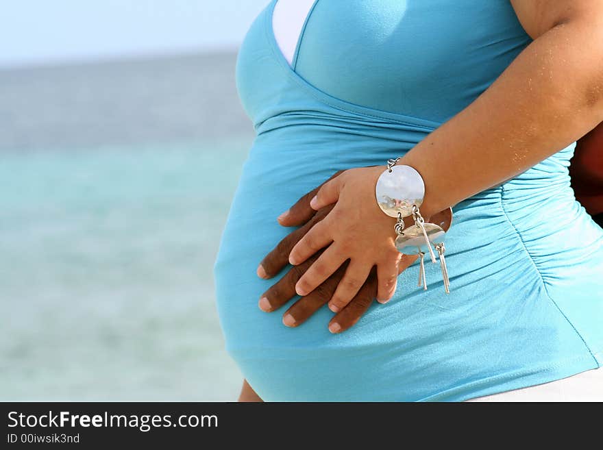 Pregnant woman with husband at sea. Pregnant woman with husband at sea