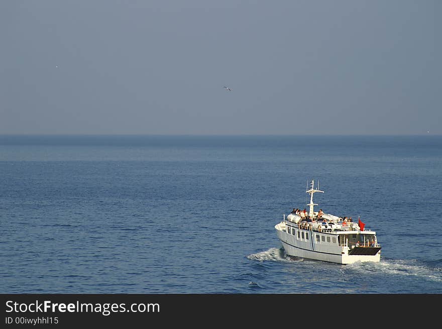 A small motorized boat in a sea - tourists carrier. A small motorized boat in a sea - tourists carrier