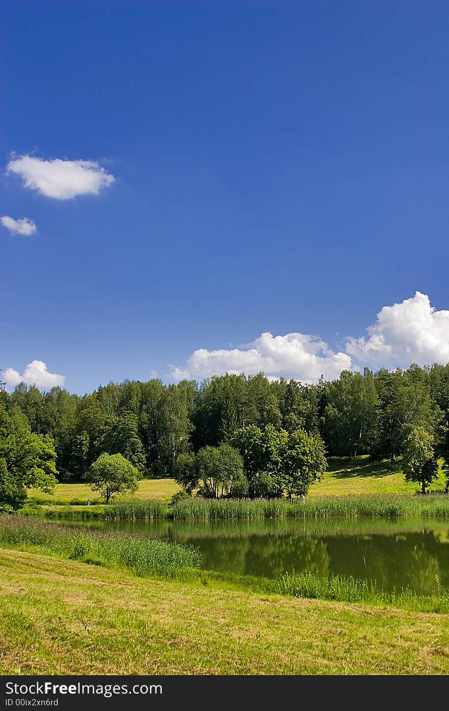 Landscape with blue sky, clouds, forest and lake. Landscape with blue sky, clouds, forest and lake