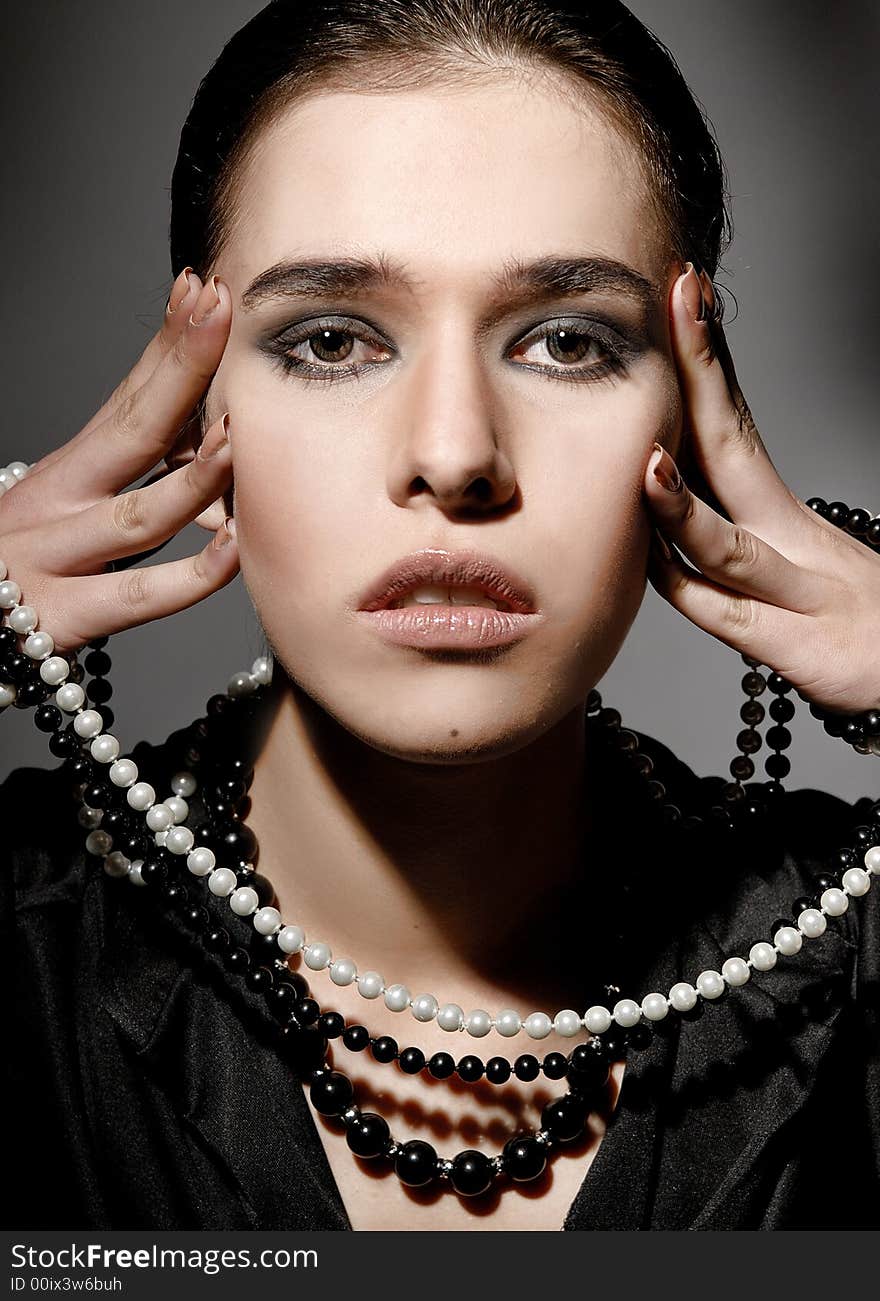 Brunette woman with white and black beads. Brunette woman with white and black beads