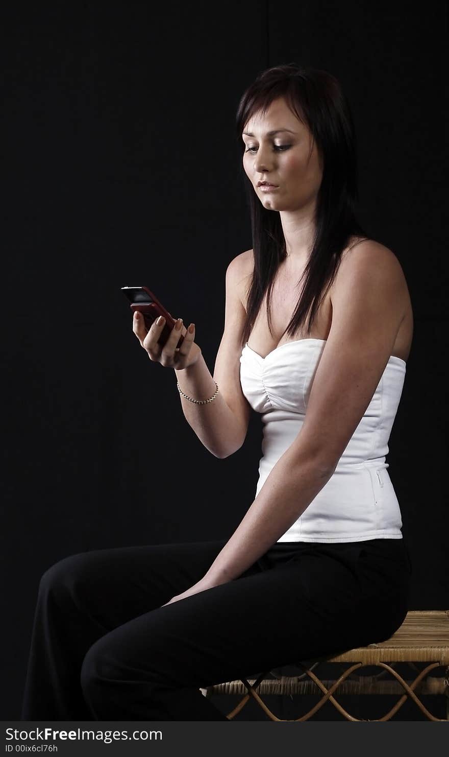 Attractive young woman calling by cellular phone. Attractive young woman calling by cellular phone