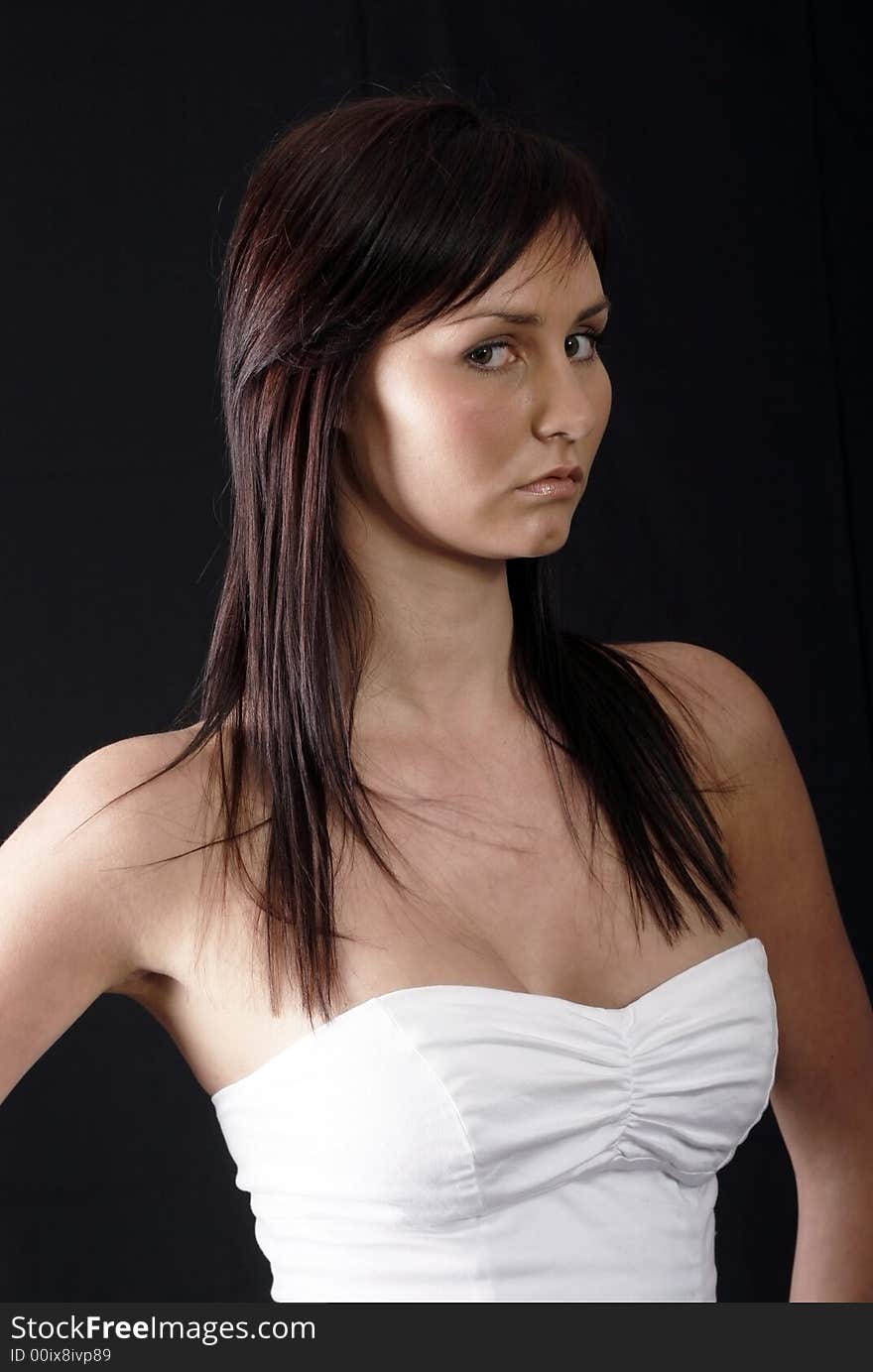 Pretty girl in white top, black background