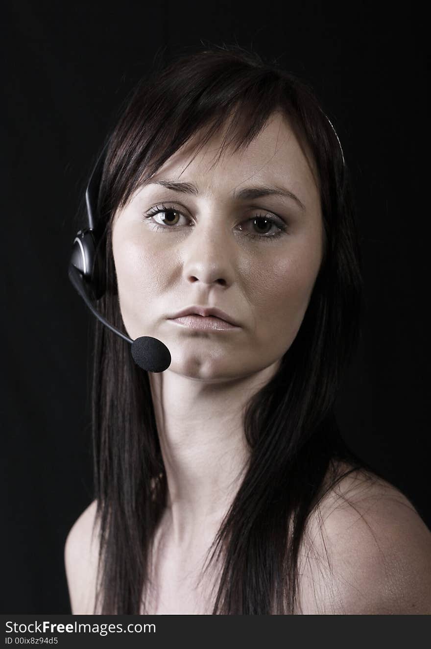 Customer service agent wearing wireless headset, on the phone