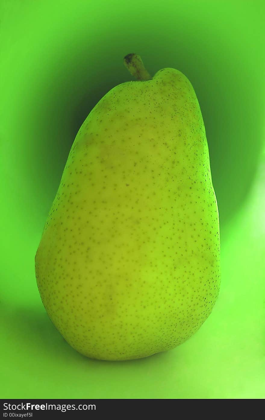 Green pear on a green background