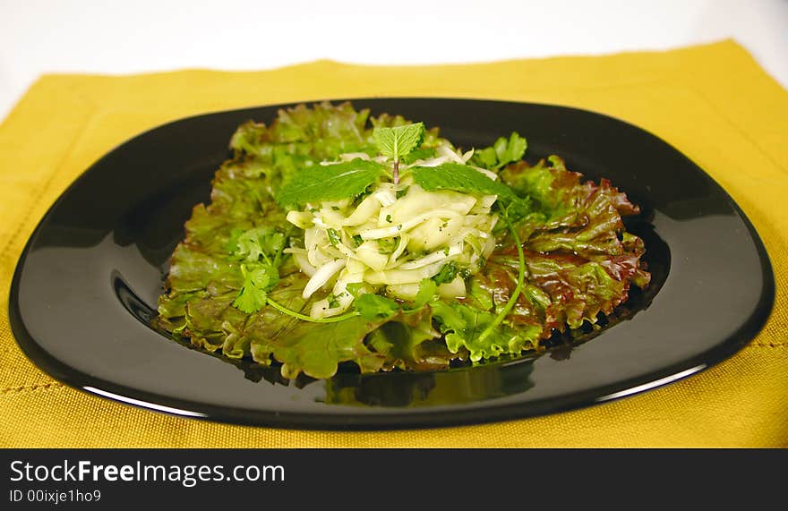 Vegetarian dish with cucumber and onion on a bed of salad. Vegetarian dish with cucumber and onion on a bed of salad