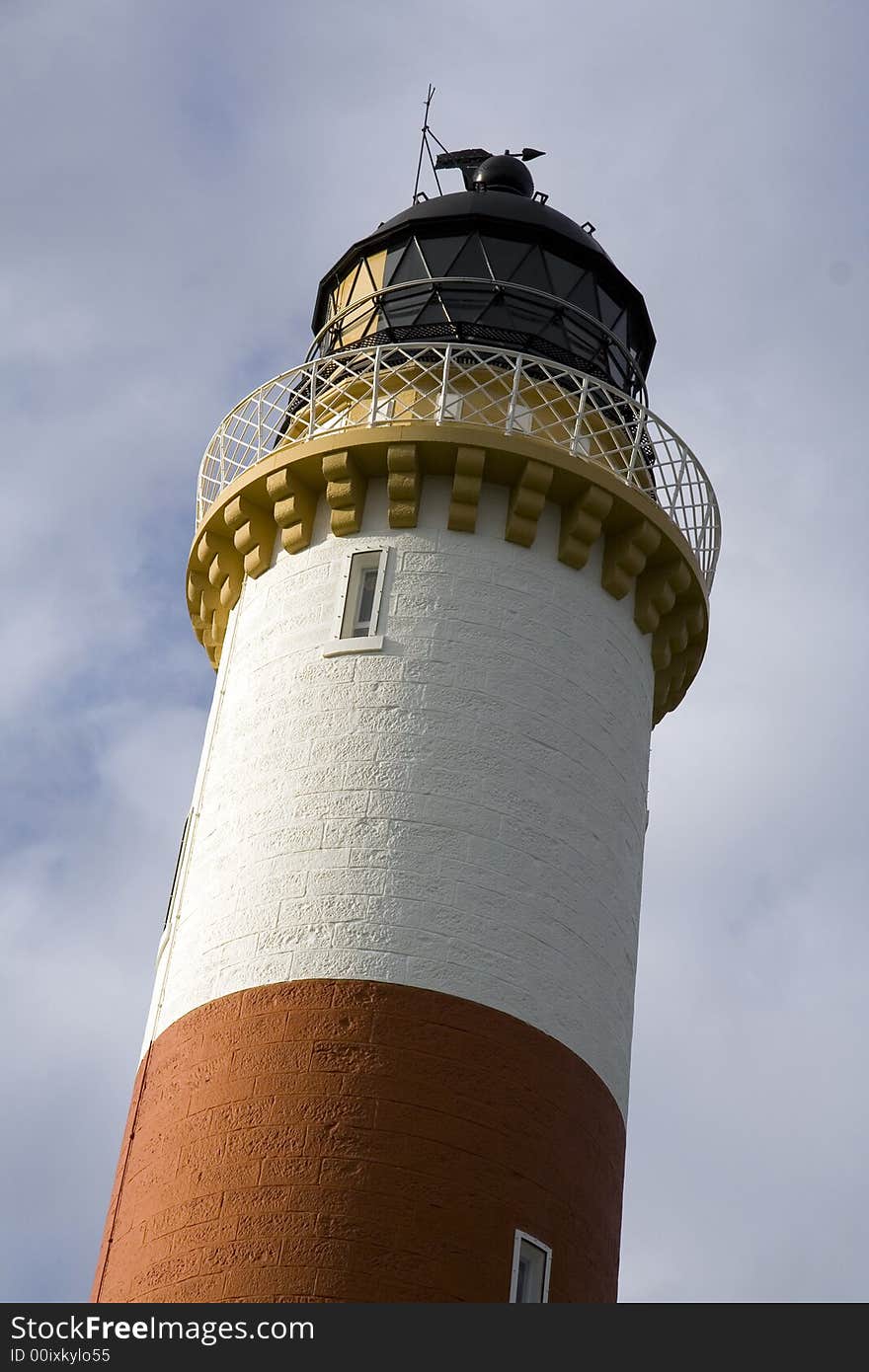 Red and white striped lighthouse on the east coast of Scotland. Red and white striped lighthouse on the east coast of Scotland