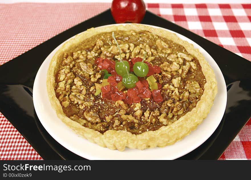 Apple tart with walnuts and green cherries