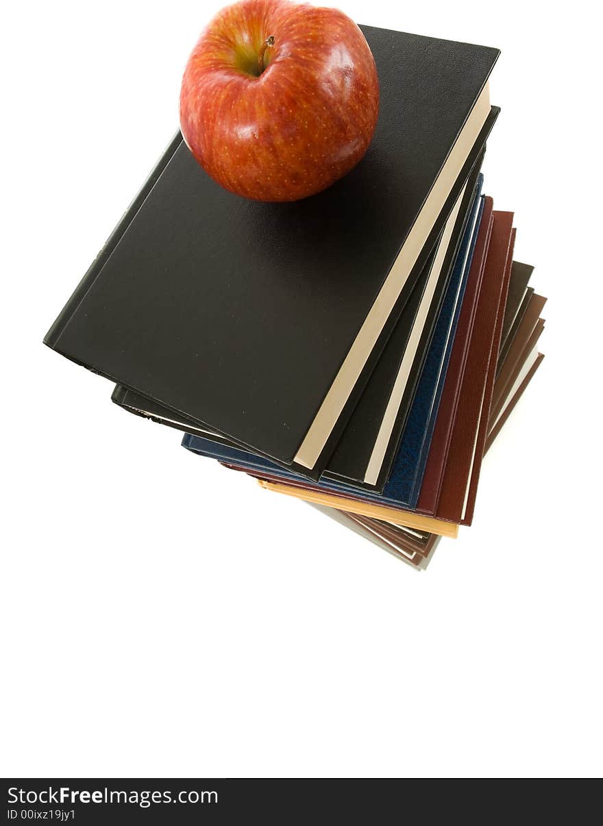 Huge stack of books with a shiny red apple on top. Huge stack of books with a shiny red apple on top