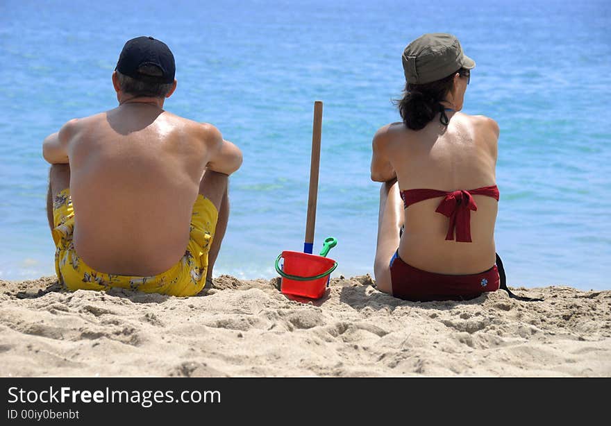 A couple on the sand beach. A couple on the sand beach