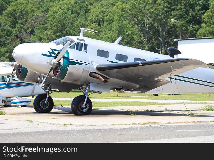 Vintage aircraft tied down at a small airport