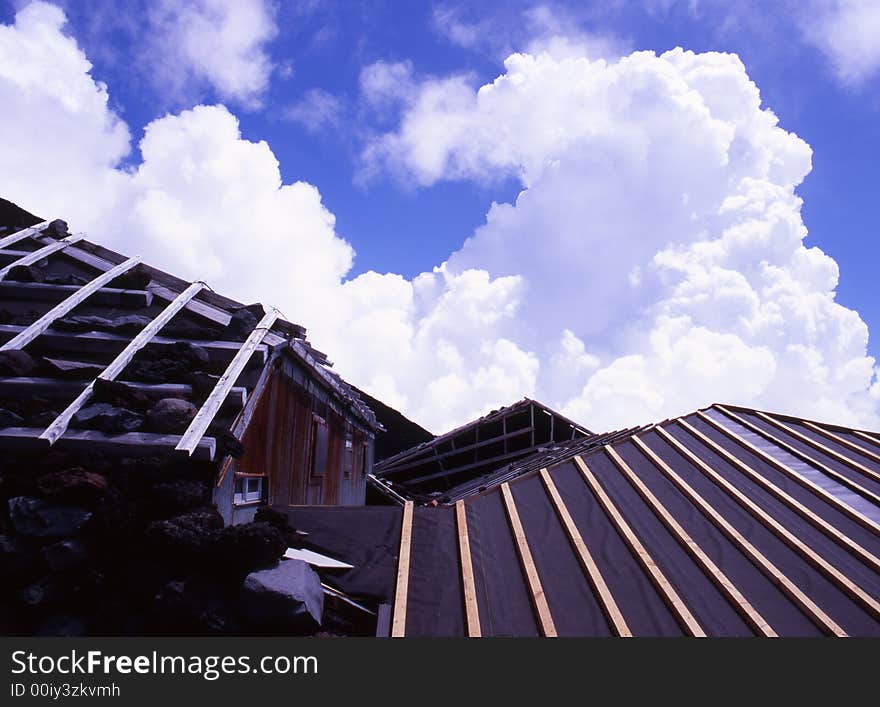 A mountain hut near the summit of Mount Fuji with billowing clouds. A mountain hut near the summit of Mount Fuji with billowing clouds