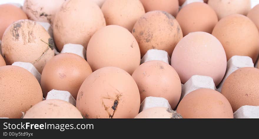 Many brown eggs in the paper case