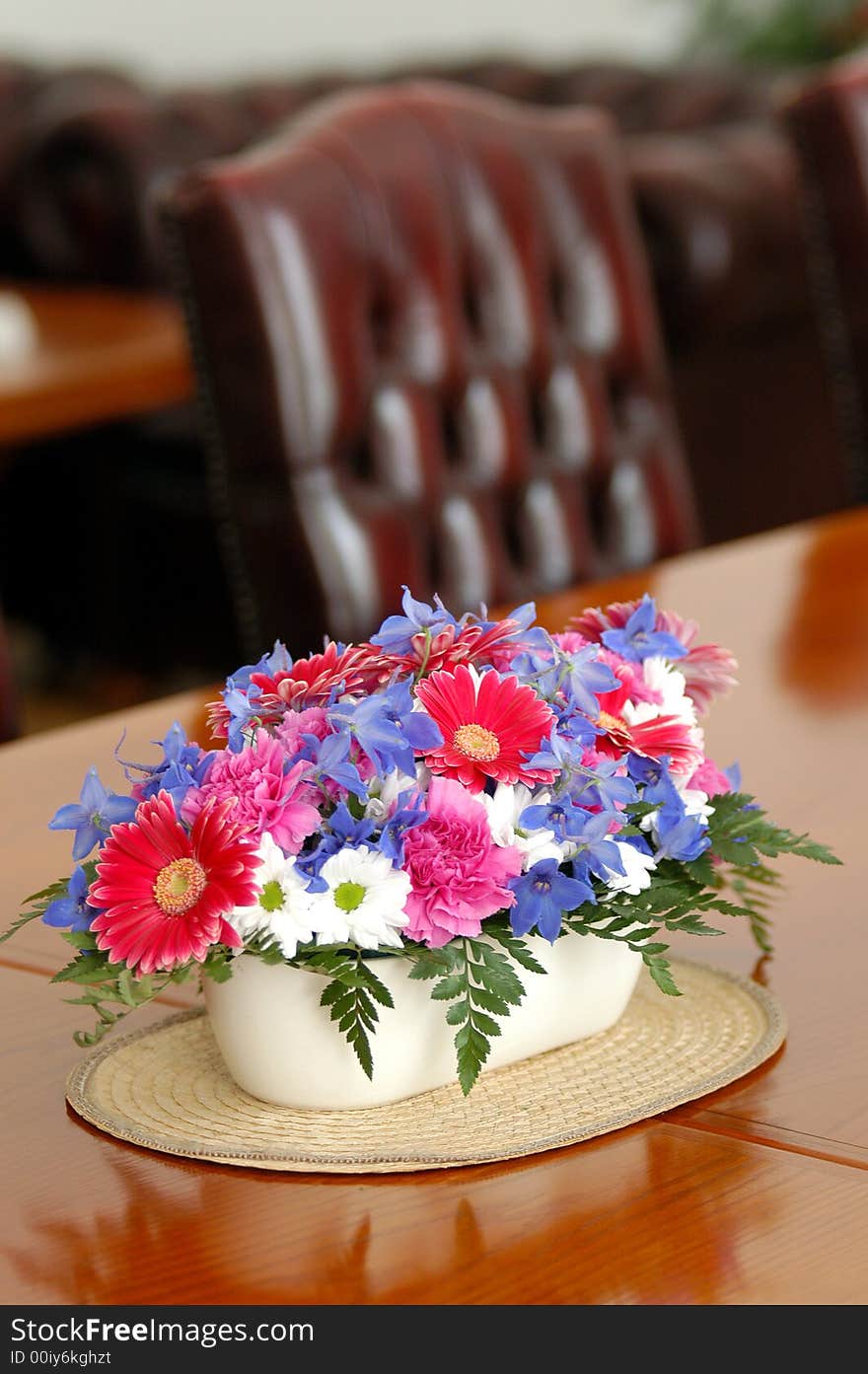 A table with seets decorated by flowers. A table with seets decorated by flowers