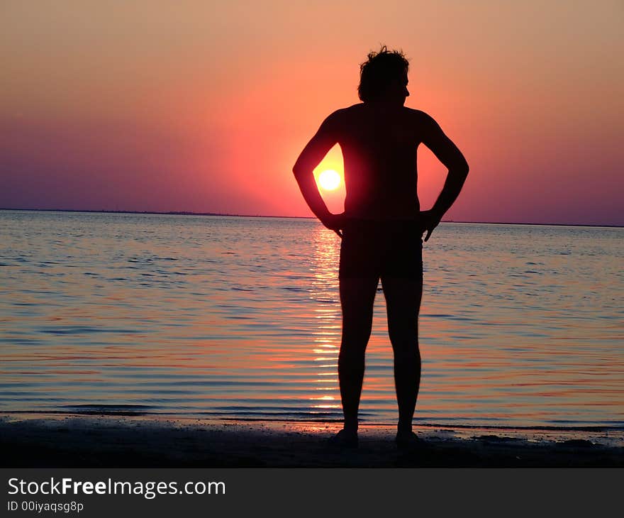 A black silhouette of a young guy on a sunset 1. A black silhouette of a young guy on a sunset 1