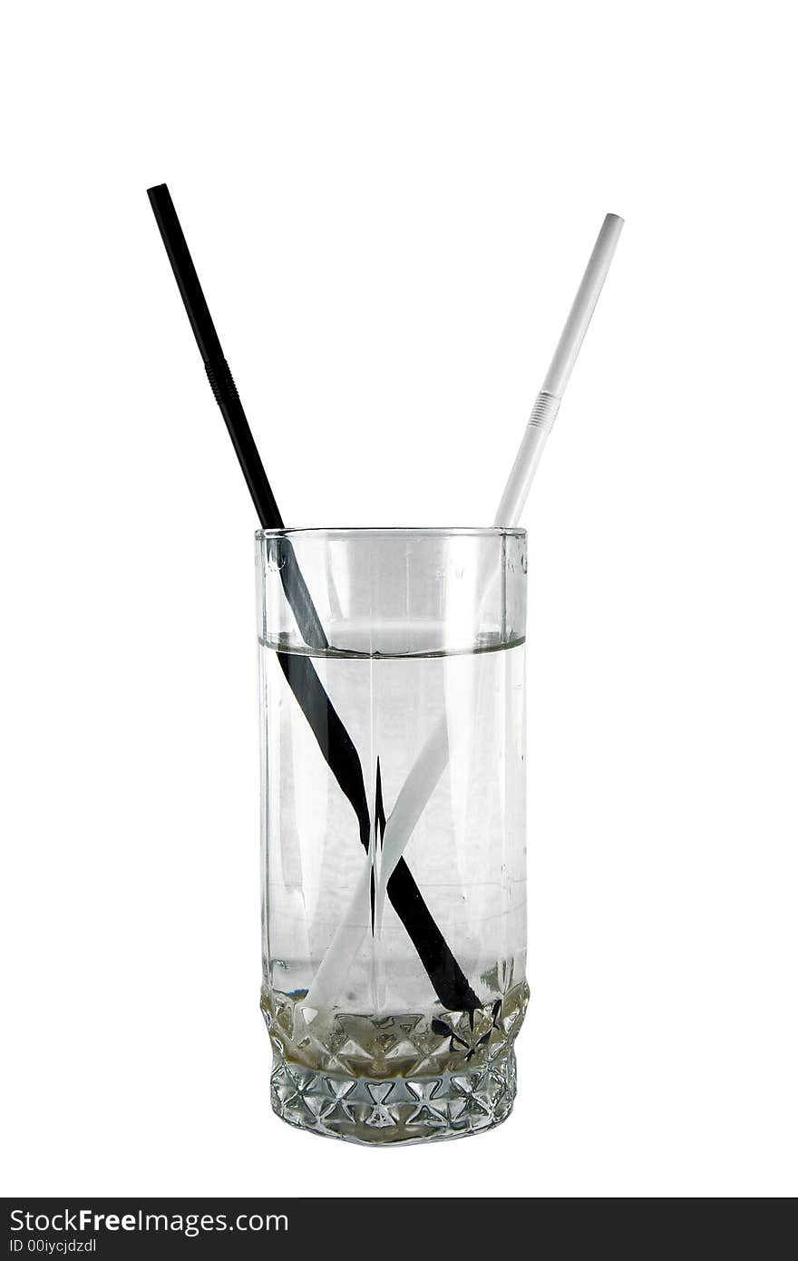 Black and white straws in glass on insulated background. Black and white straws in glass on insulated background