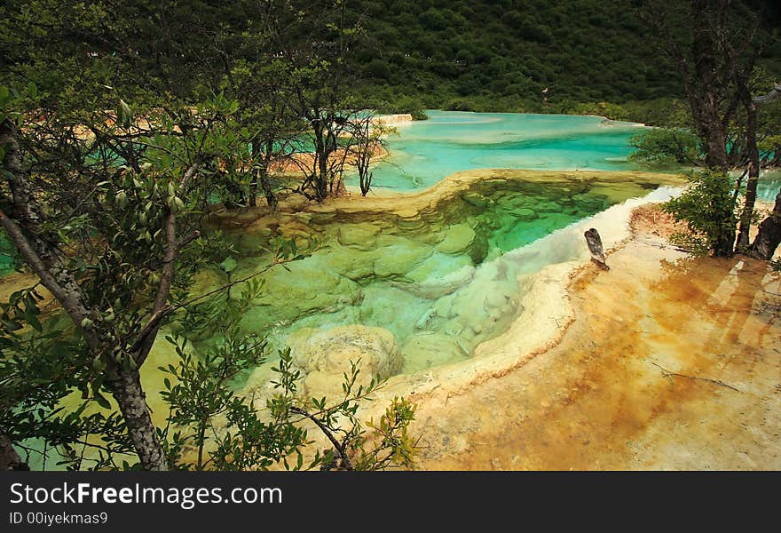 Limestone formations and hot springs in the Huanglong Valley, China. Limestone formations and hot springs in the Huanglong Valley, China.