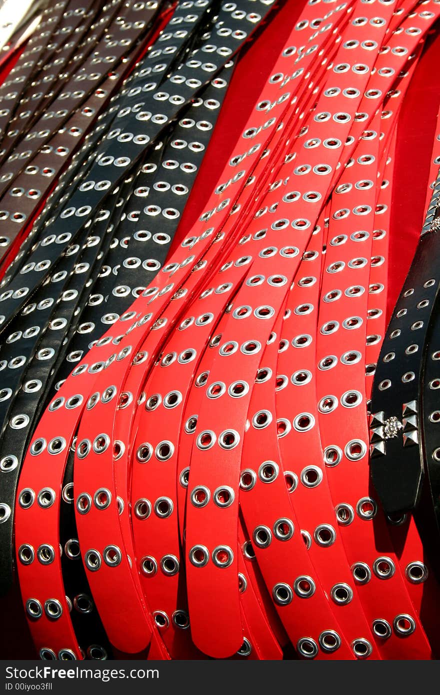 A bunch of belts at a flea market