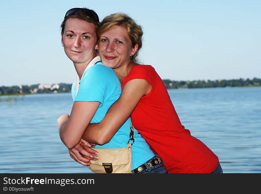 Two  women stand in lake