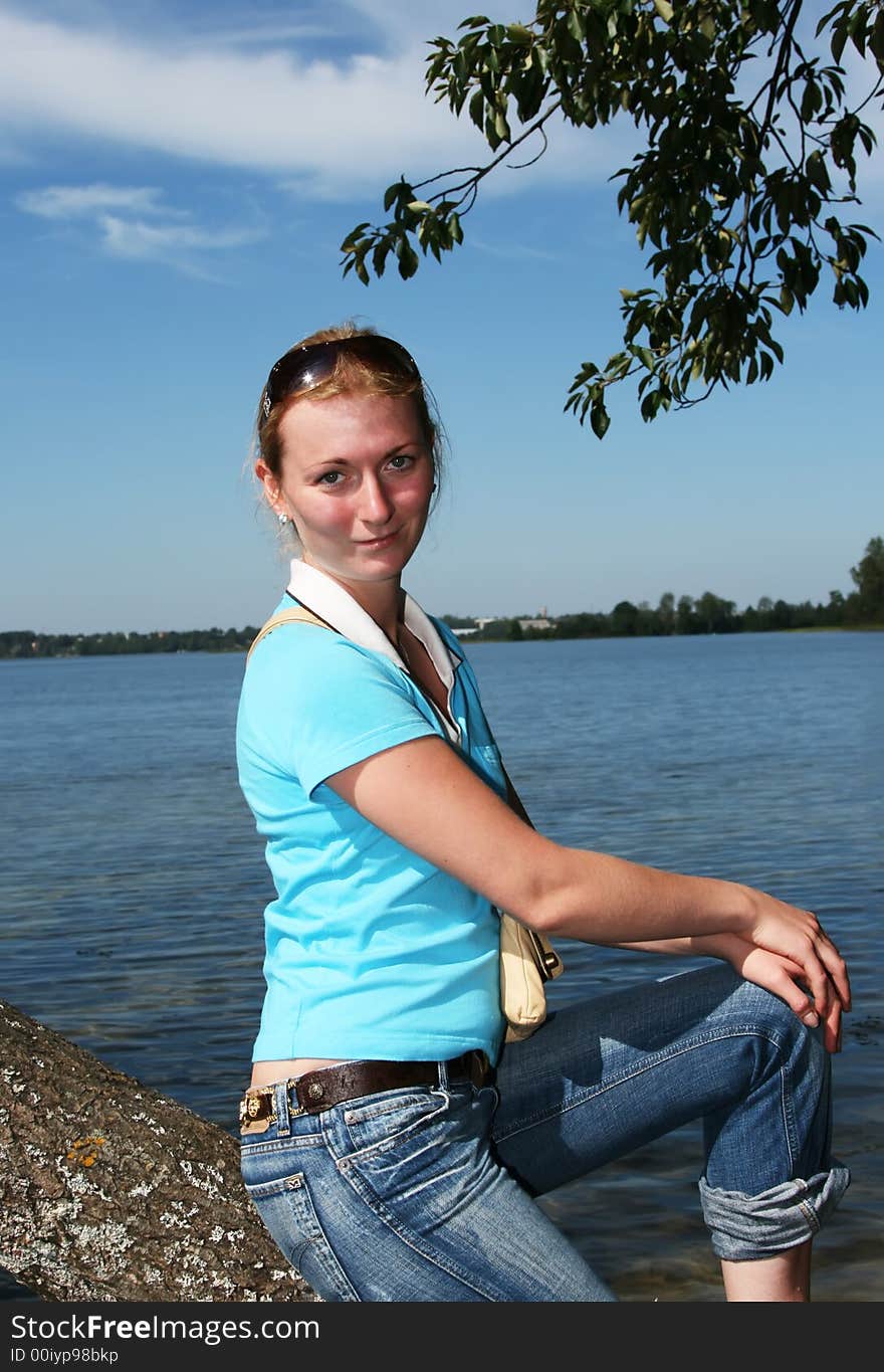 Young woman sitting on a tree