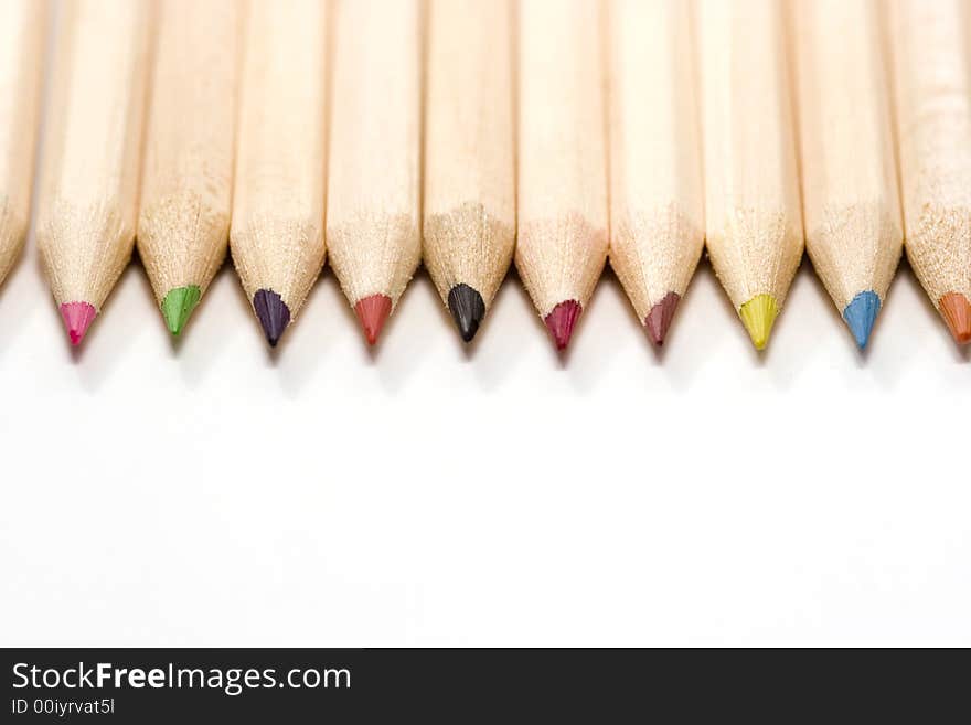 Wooden color pencils in line isolated on white