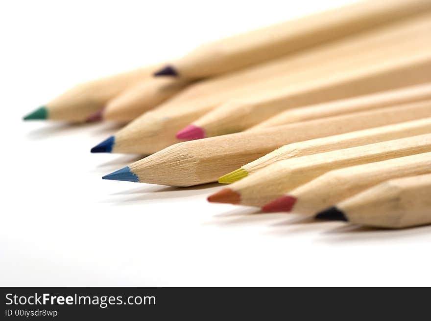 Wooden color pencils in stack isolated on white