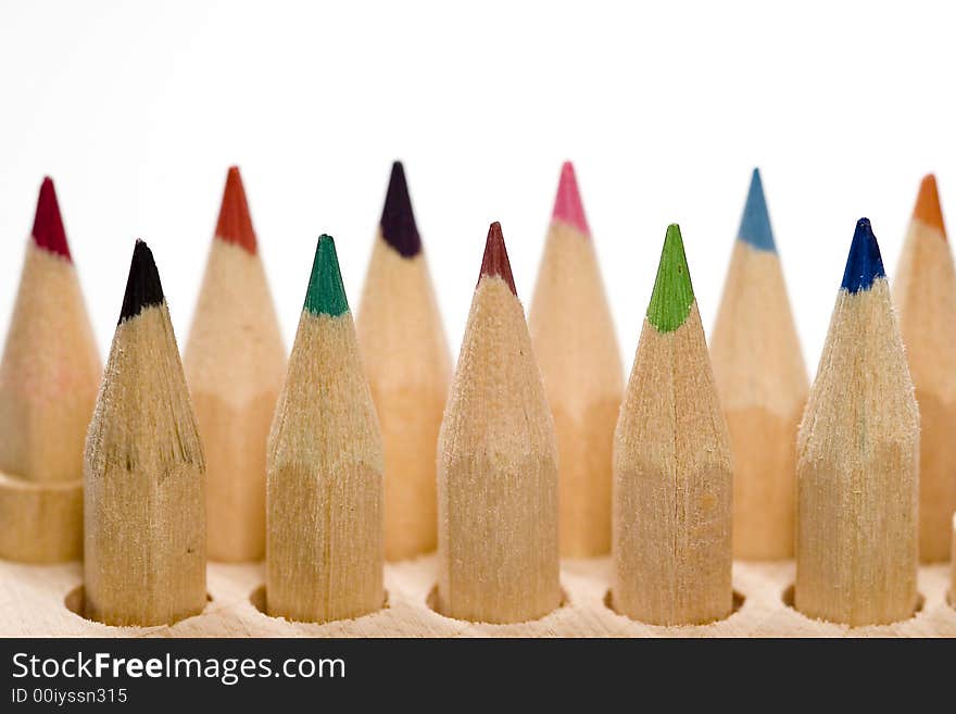 Wooden color pencils in line isolated on white