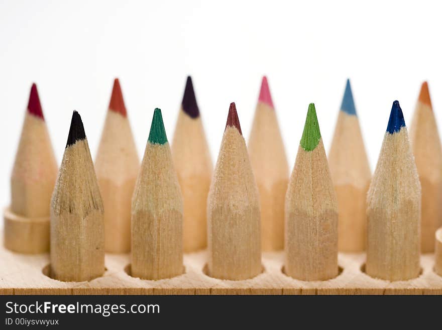 Wooden color pencils in line isolated on white