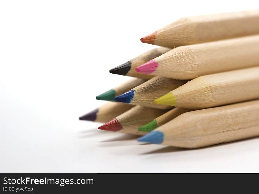 Wooden color pencils in stack isolated on white