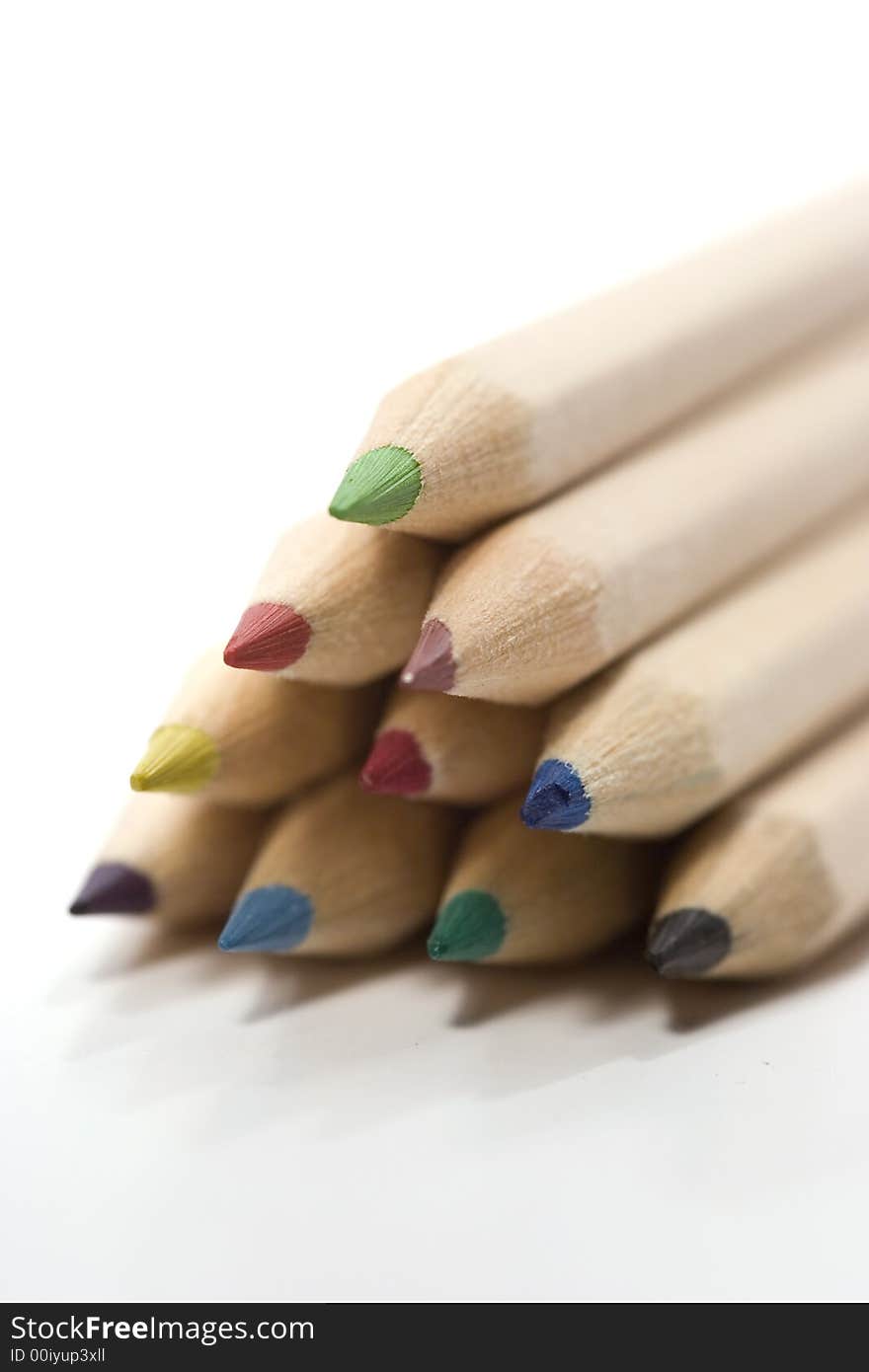 Wooden color pencils in stack isolated on white