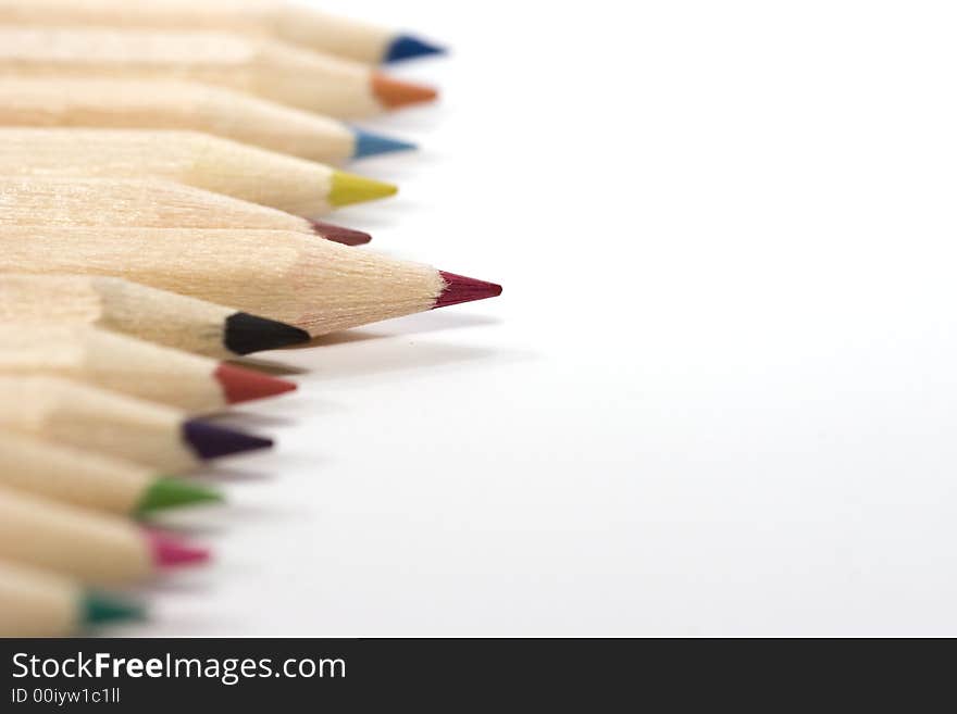 Wooden color pencils in line isolated on white