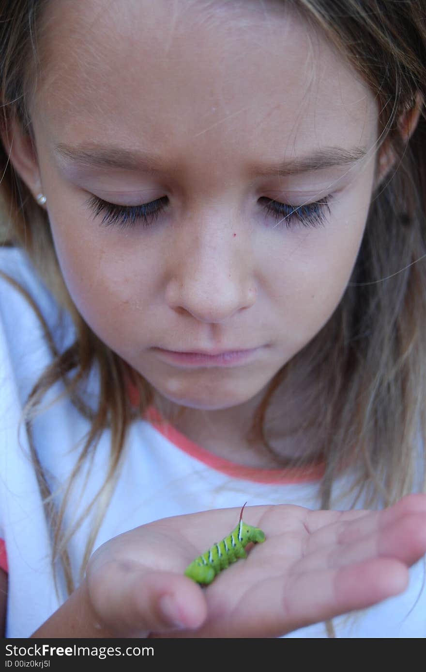 Girl showing off Tobcco hornworm larvae. Girl showing off Tobcco hornworm larvae