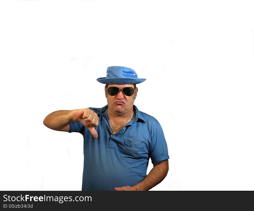 A man wearing a hat and sunglasses pointing his thumb down, over white. A man wearing a hat and sunglasses pointing his thumb down, over white