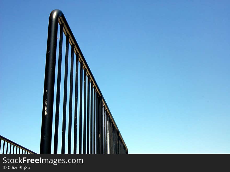 Playground railing shot from a low angle fading off into the distance