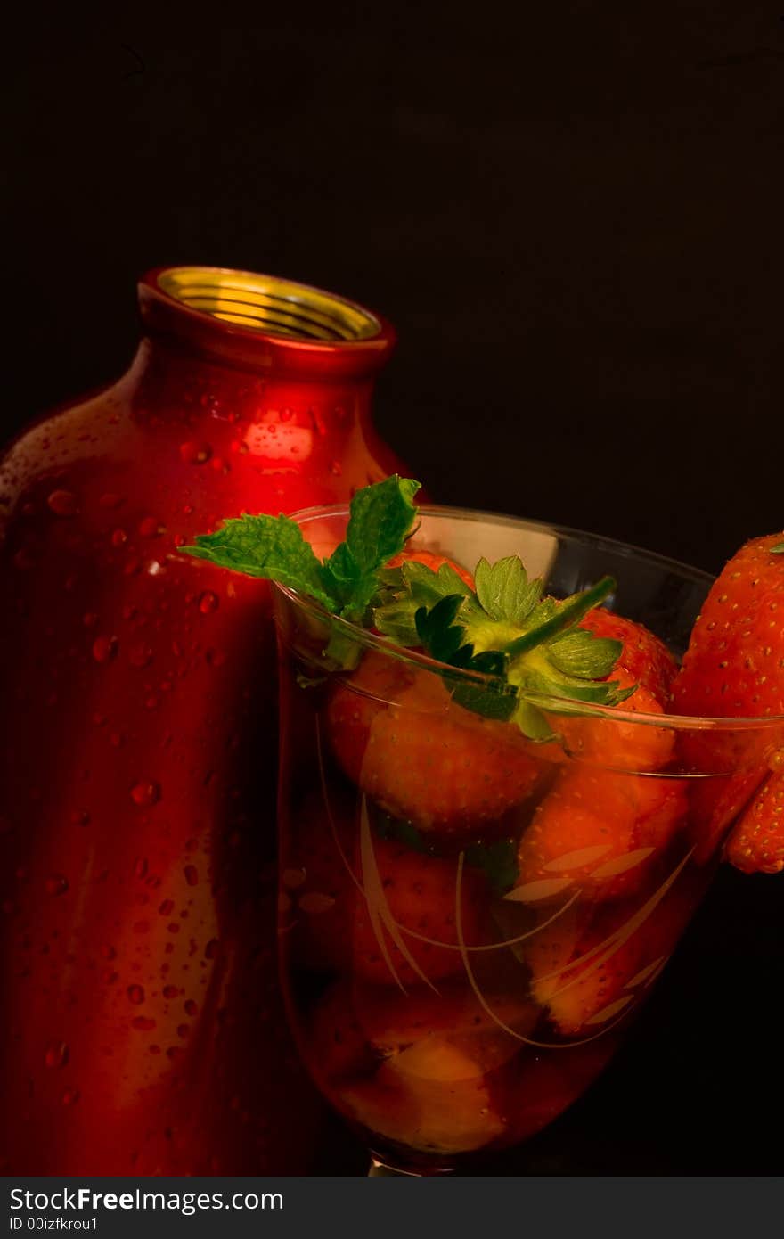 Strawberry ice cocktail with cocktail shaker on black background. Strawberry ice cocktail with cocktail shaker on black background