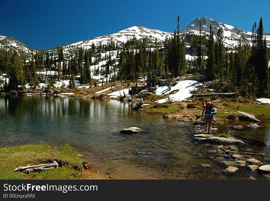 An alpine lake backdropped by snowcapped peaks. An alpine lake backdropped by snowcapped peaks