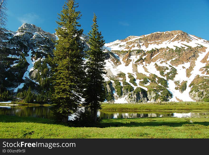 Morning dawns bright at an alpine lake. Morning dawns bright at an alpine lake