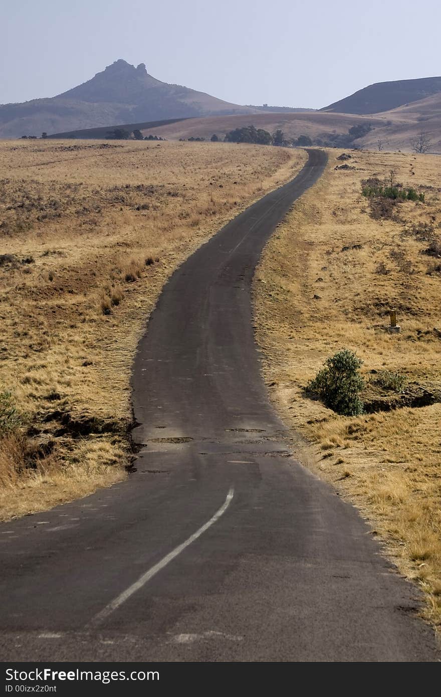 Old damaged and deserted road with many potholes. Old damaged and deserted road with many potholes