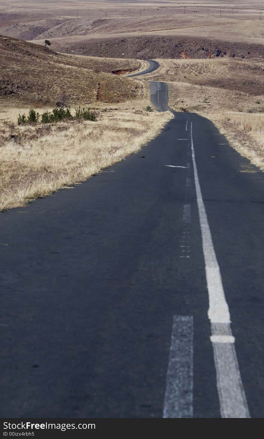 Old deserted road going down a hill in South Africa. Old deserted road going down a hill in South Africa