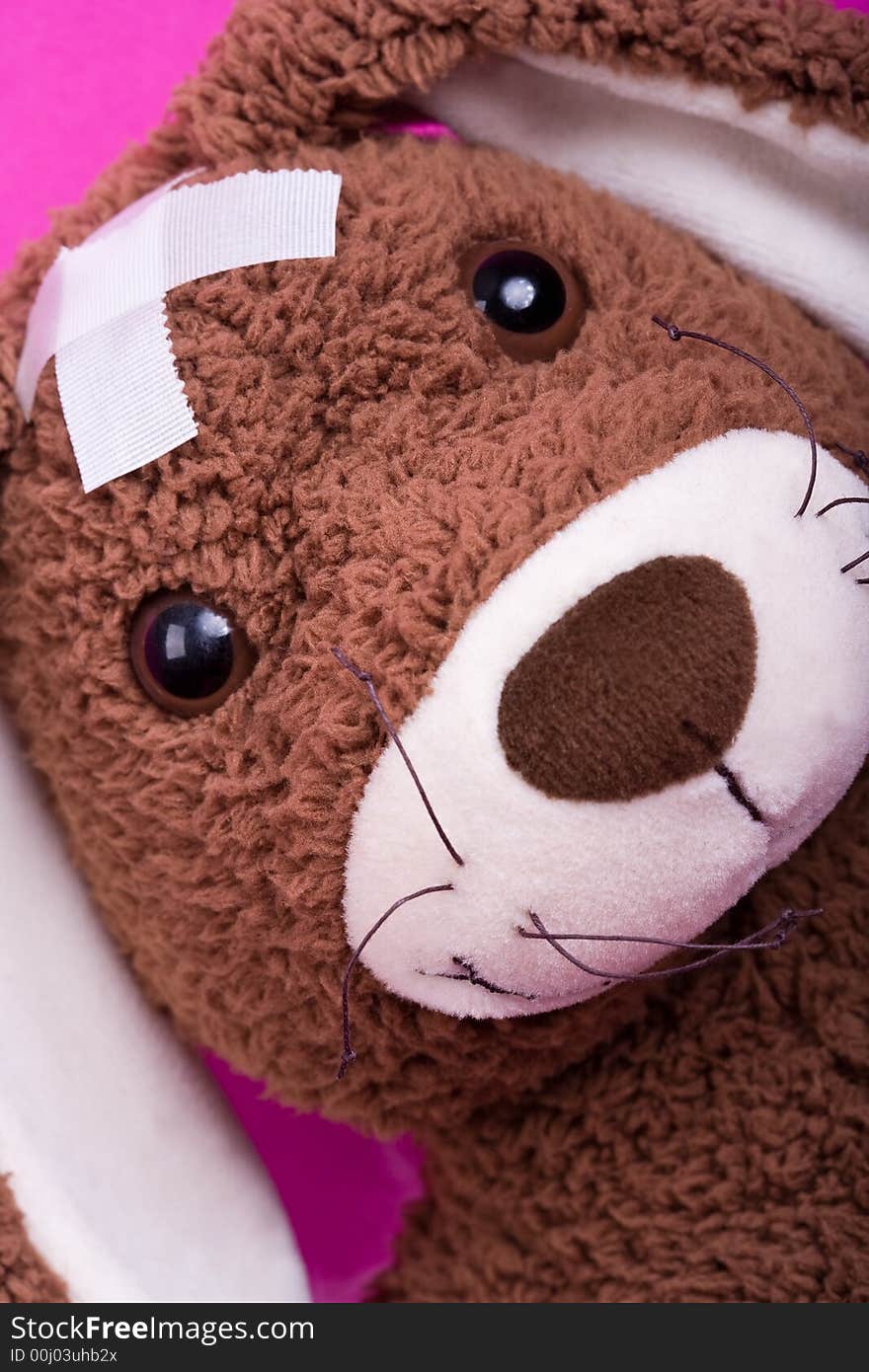 Closeup of cuddly-toy (rabbit) with two white patches on his head. He is ill. Closeup of cuddly-toy (rabbit) with two white patches on his head. He is ill.