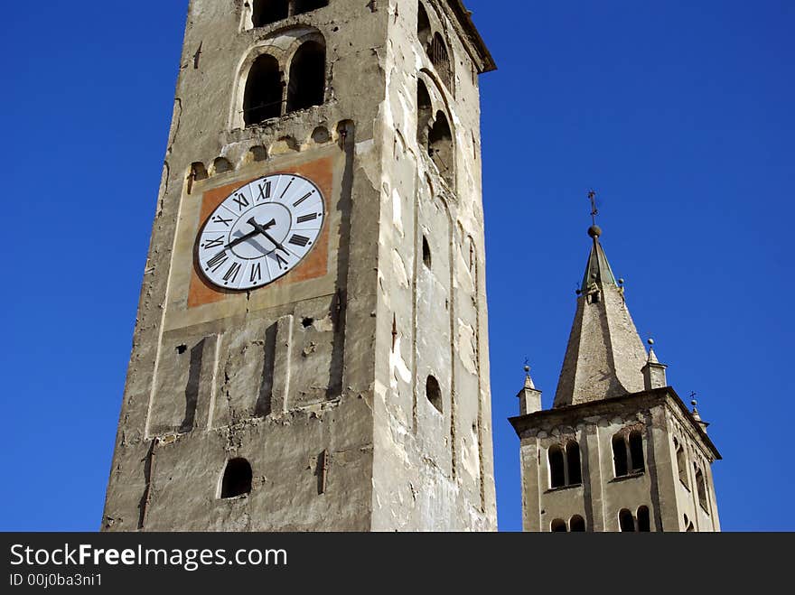 Details of clock tower of a very old church in Aosta, Italy. Details of clock tower of a very old church in Aosta, Italy.