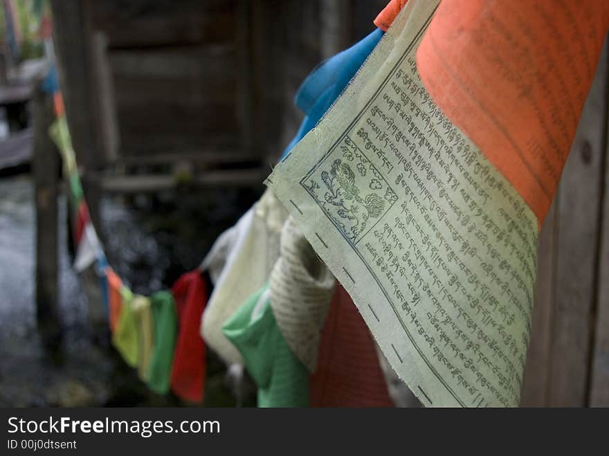 Colorful flags with Tibetan Buddhist scriptures on them. They are hung so that when the wind blows it is thought that the scriptures are being read by and carried by he wind. Colorful flags with Tibetan Buddhist scriptures on them. They are hung so that when the wind blows it is thought that the scriptures are being read by and carried by he wind.