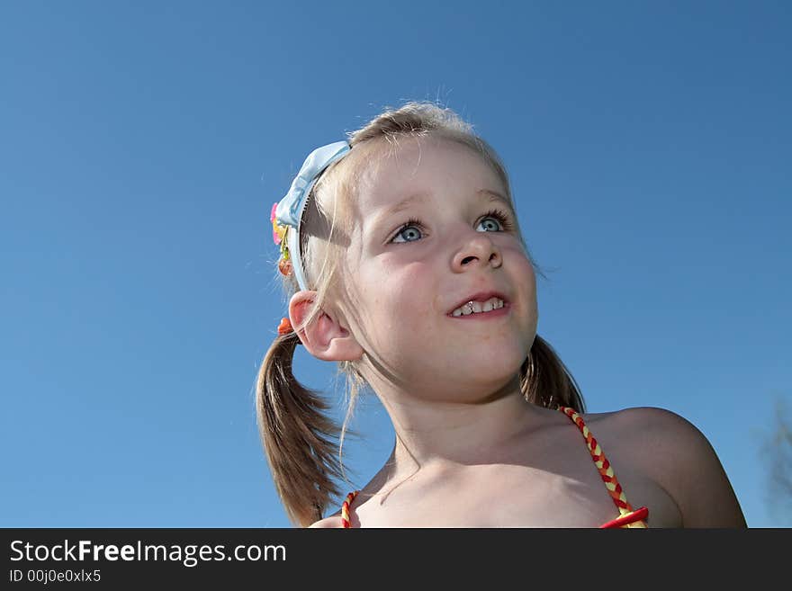 The happy girl smiles outdoor in the sky background. The happy girl smiles outdoor in the sky background