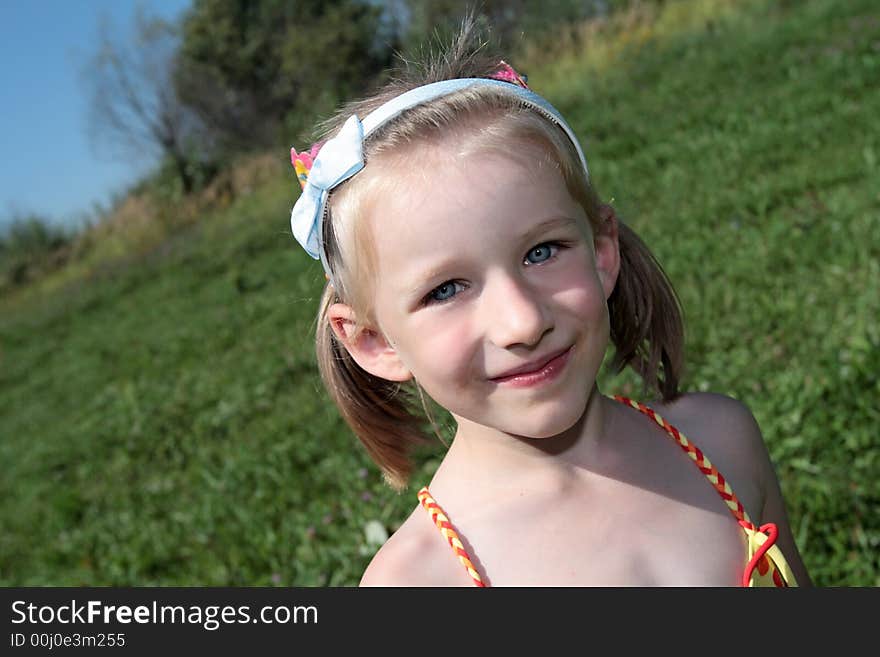 The happy girl smiles outdoor at summer. The happy girl smiles outdoor at summer