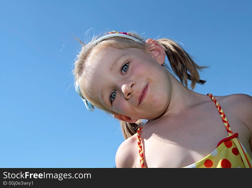 The happy girl laughs outdoor at summer