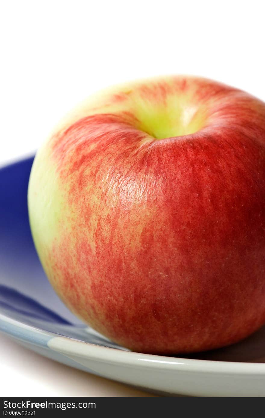 Closeup of red apple on the plate.