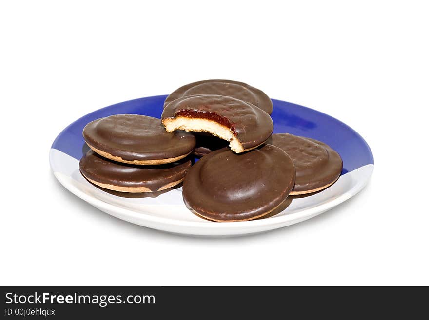 A pile of chocolate cookies on the plate, isolated on white background.